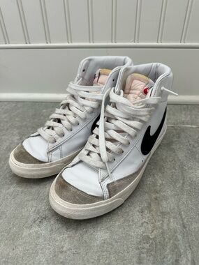Nike White High-Top Sneakers with Black Swoosh